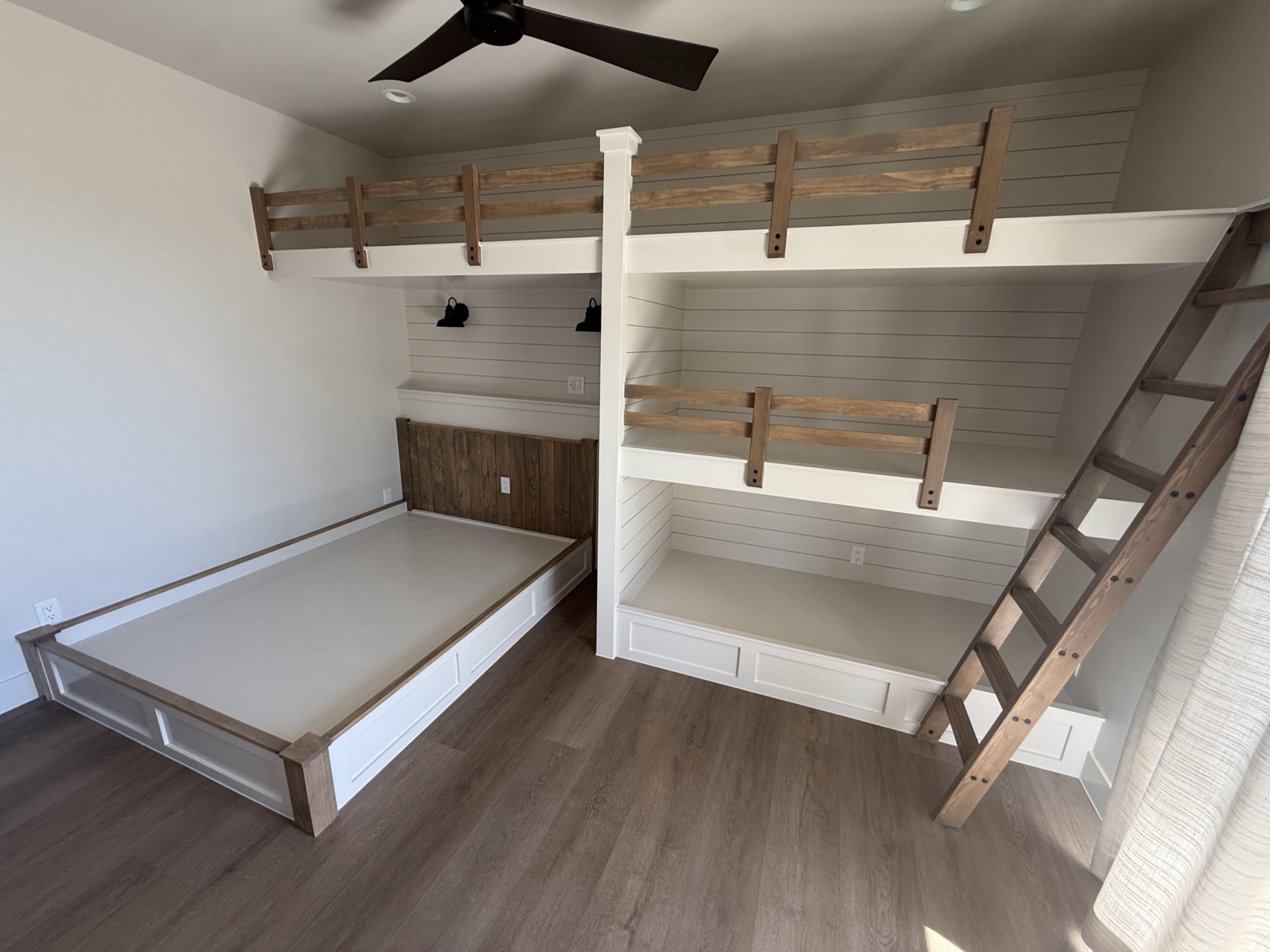Built-in bunk beds finished — painted shiplap with stained rails