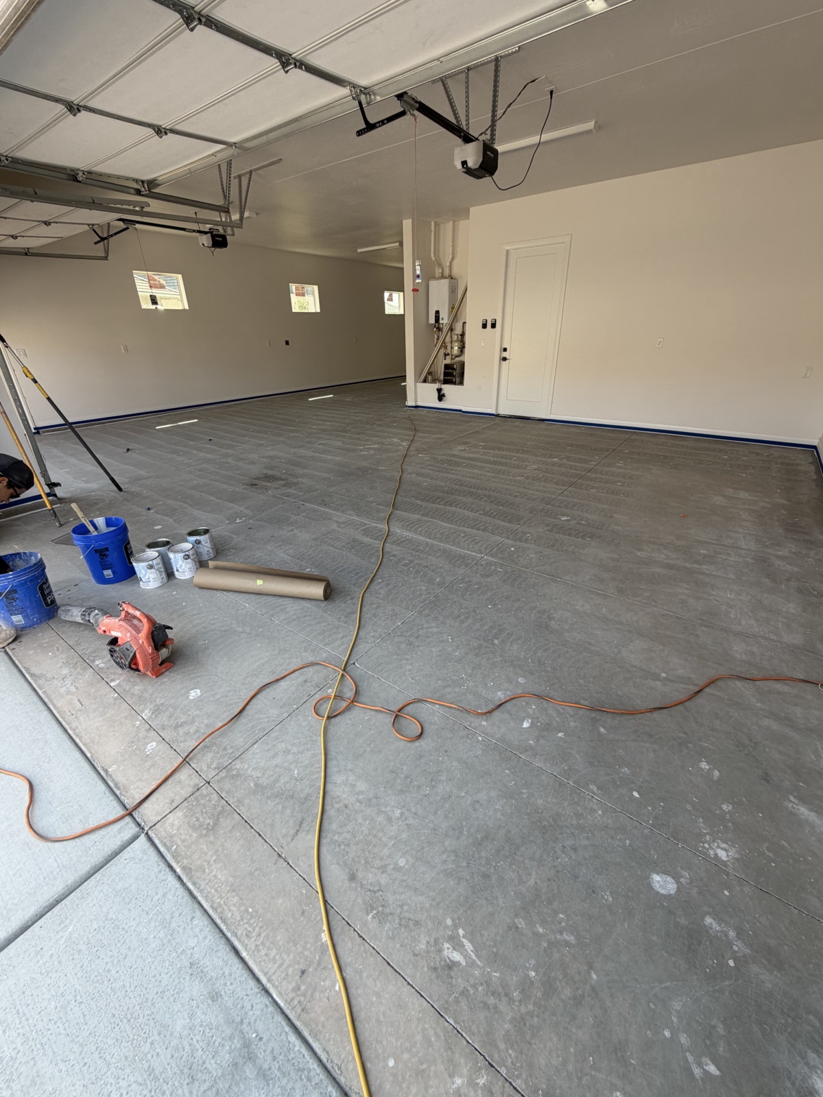 Garage floor before — bare, cracked concrete slab